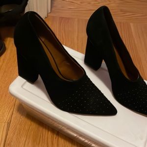 Black suede shoes with black pebbles on top